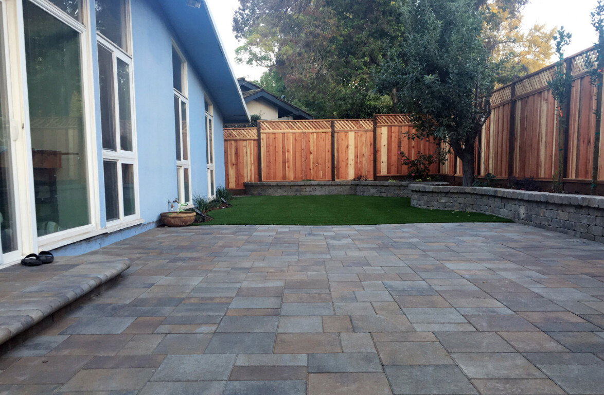 Beautiful backyard concrete patio with decorative pavers